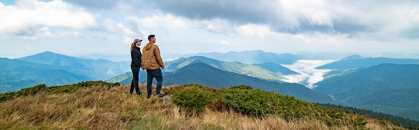 A couple of people standing on top of a mountain