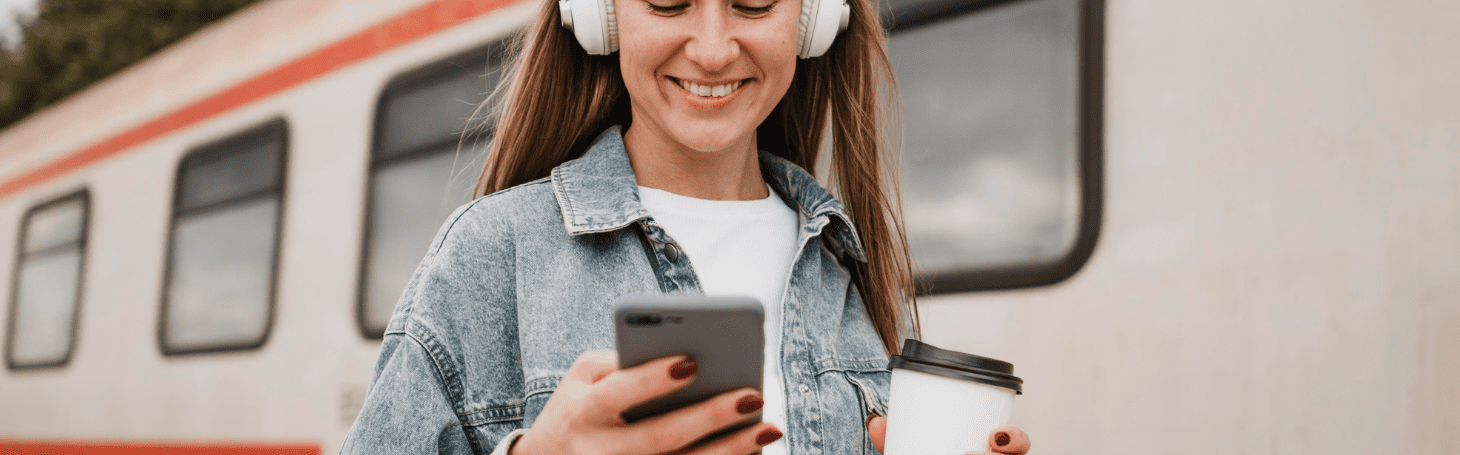 Woman on platform looking at phone