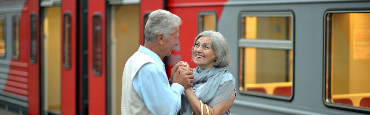 Two elderly people by the train