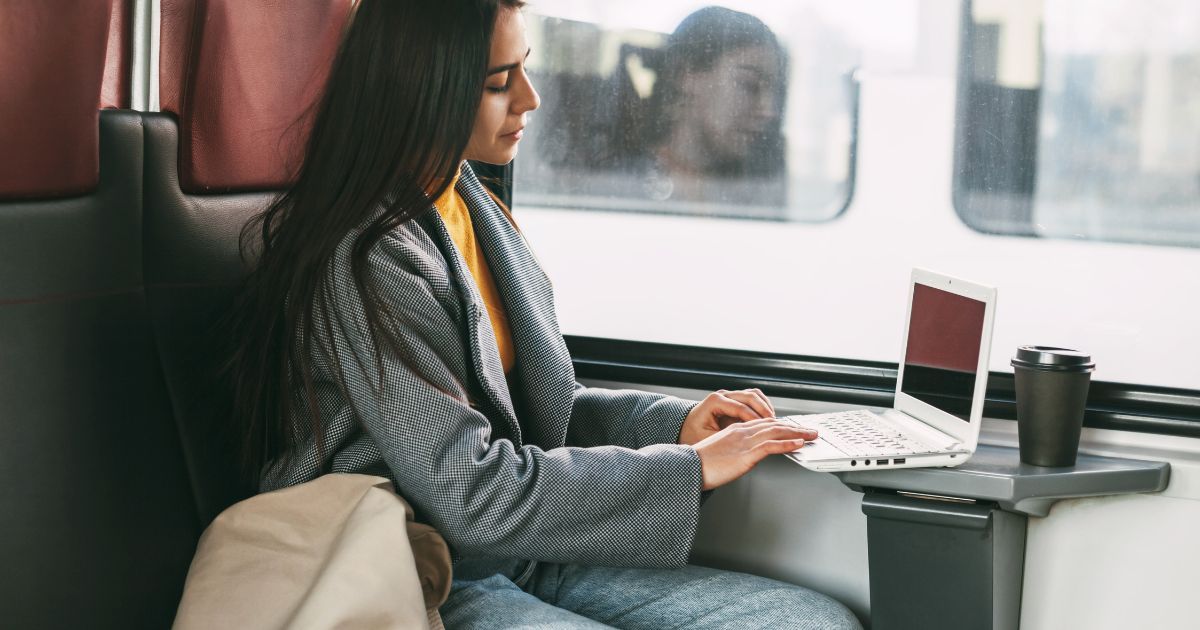 Woman on a train with a laptop