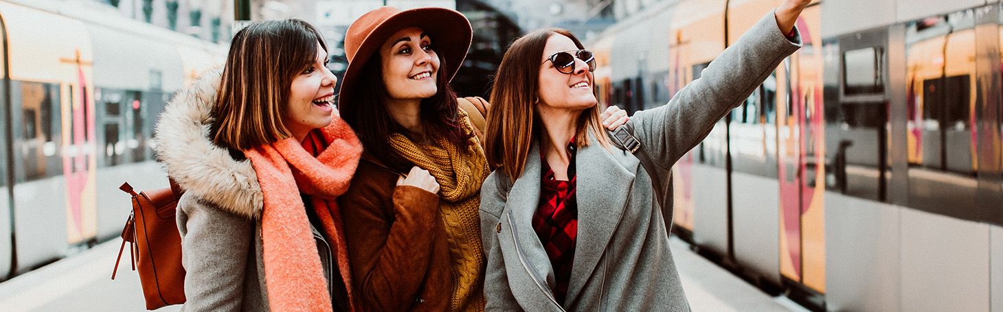 Women taking a picture of themselves on the platform