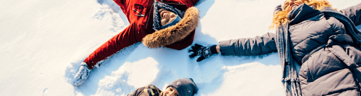 children in the snow making an angel