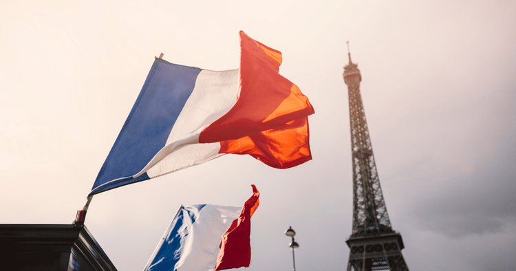 the flag of france against the background of the eiffel tower