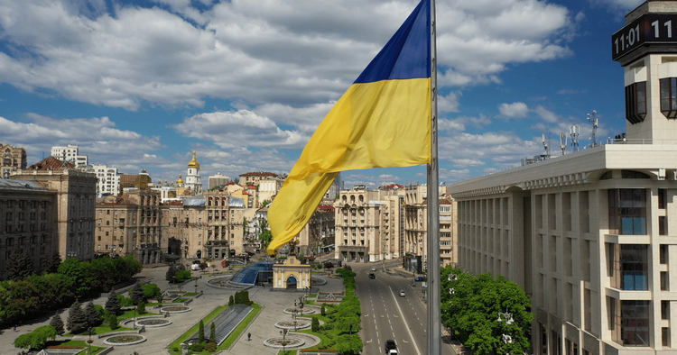 the flag of Ukraine against a background of buildings