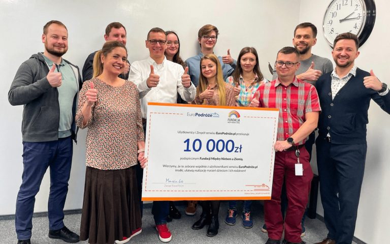 PolishTrains support staff holding a voucher for the foundation