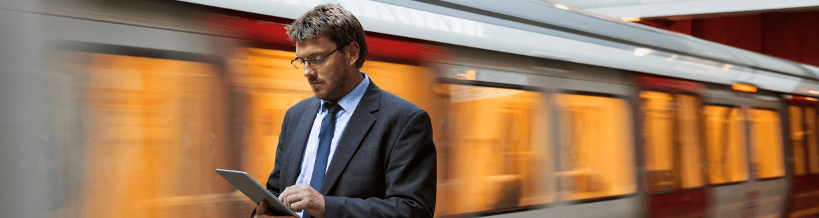 business trips with PKP man with tablet in hand against the background of a train